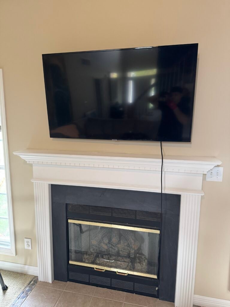 Wall-mounted TV installation above fireplace in Louisville, KY