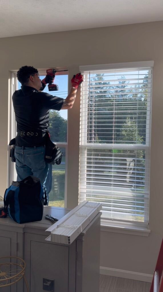 Javi performing blinds installation for a residential client