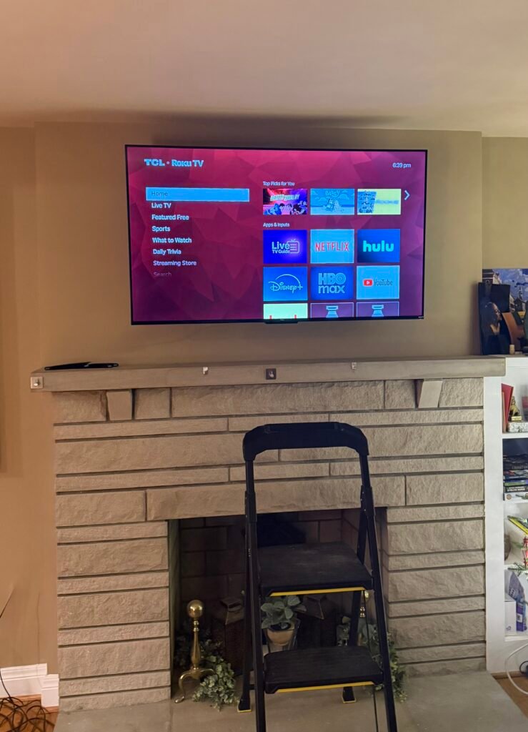 TV mounted above fireplace in Shepherdsville KY on a stone wall with professional and sturdy mounting