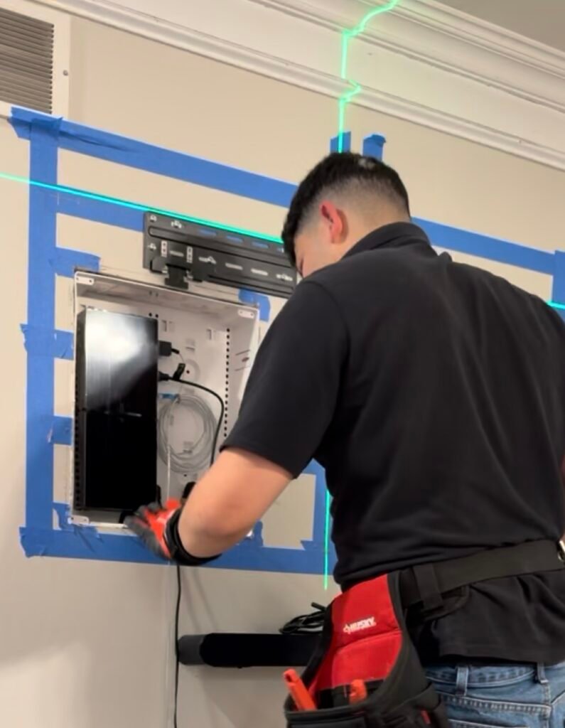 Recessed wall box installation behind TV with One Connect Box hidden, pre-mount setup for flush TV installation in Prospect KY