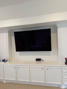 TV in a recessed wall between cabinets