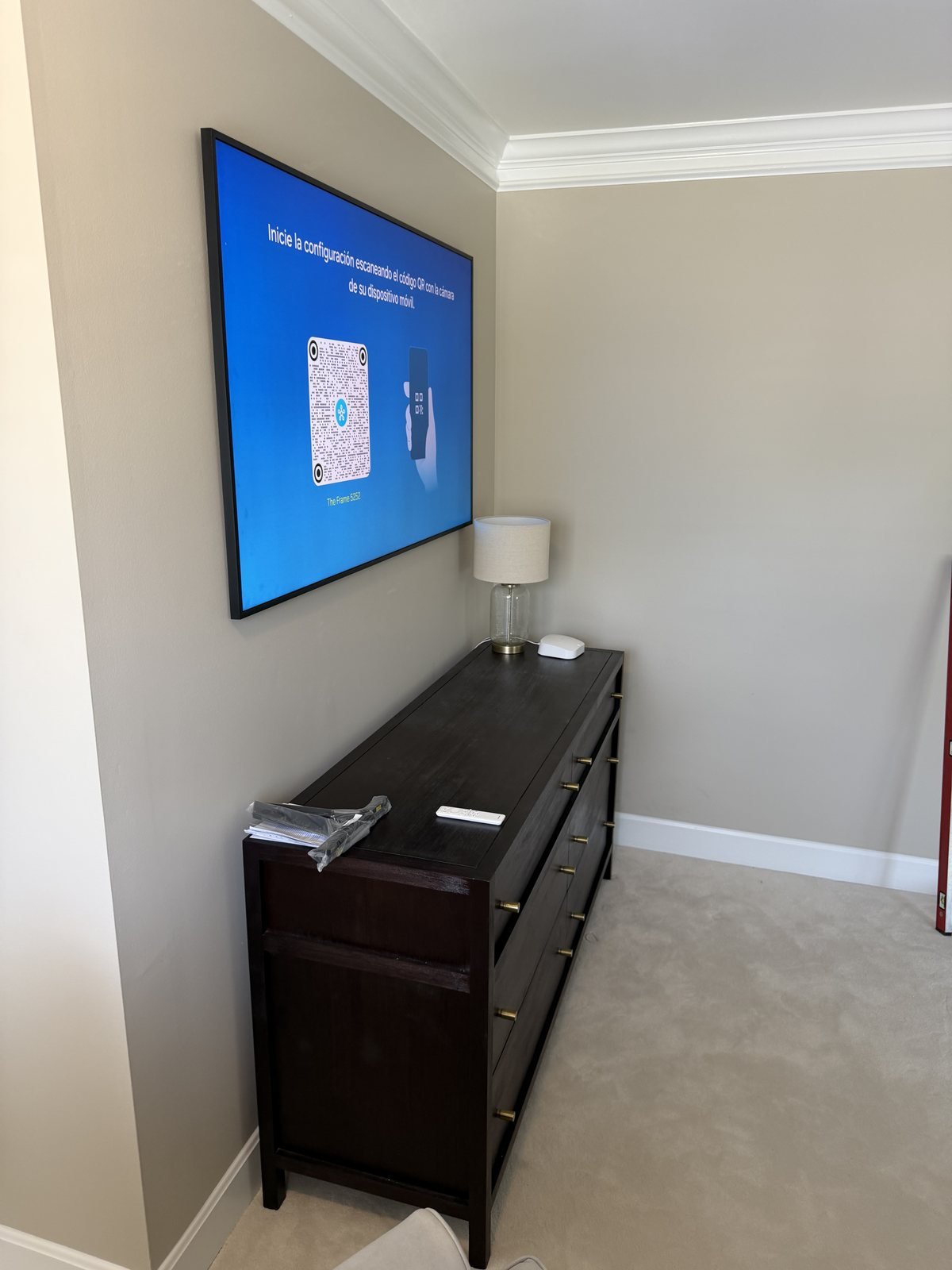 TV Mounting in Hurstbourne, KY Side view of a Samsung Frame above a dark cabinet during setup in Hurstbourne, Kentucky