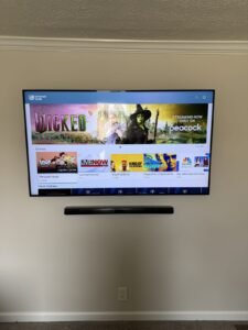 TV and soundbar aligned on a light painted wall