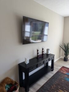 Wall-mounted TV above a media console