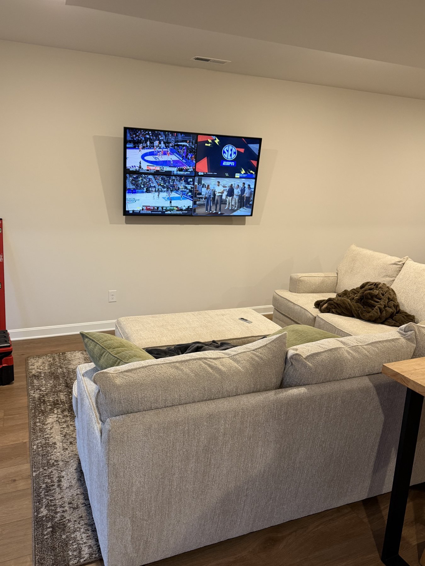 TV Mounting in Prospect, KY 75-inch TV on a cream living-room wall above a sectional sofa in Prospect, Kentucky