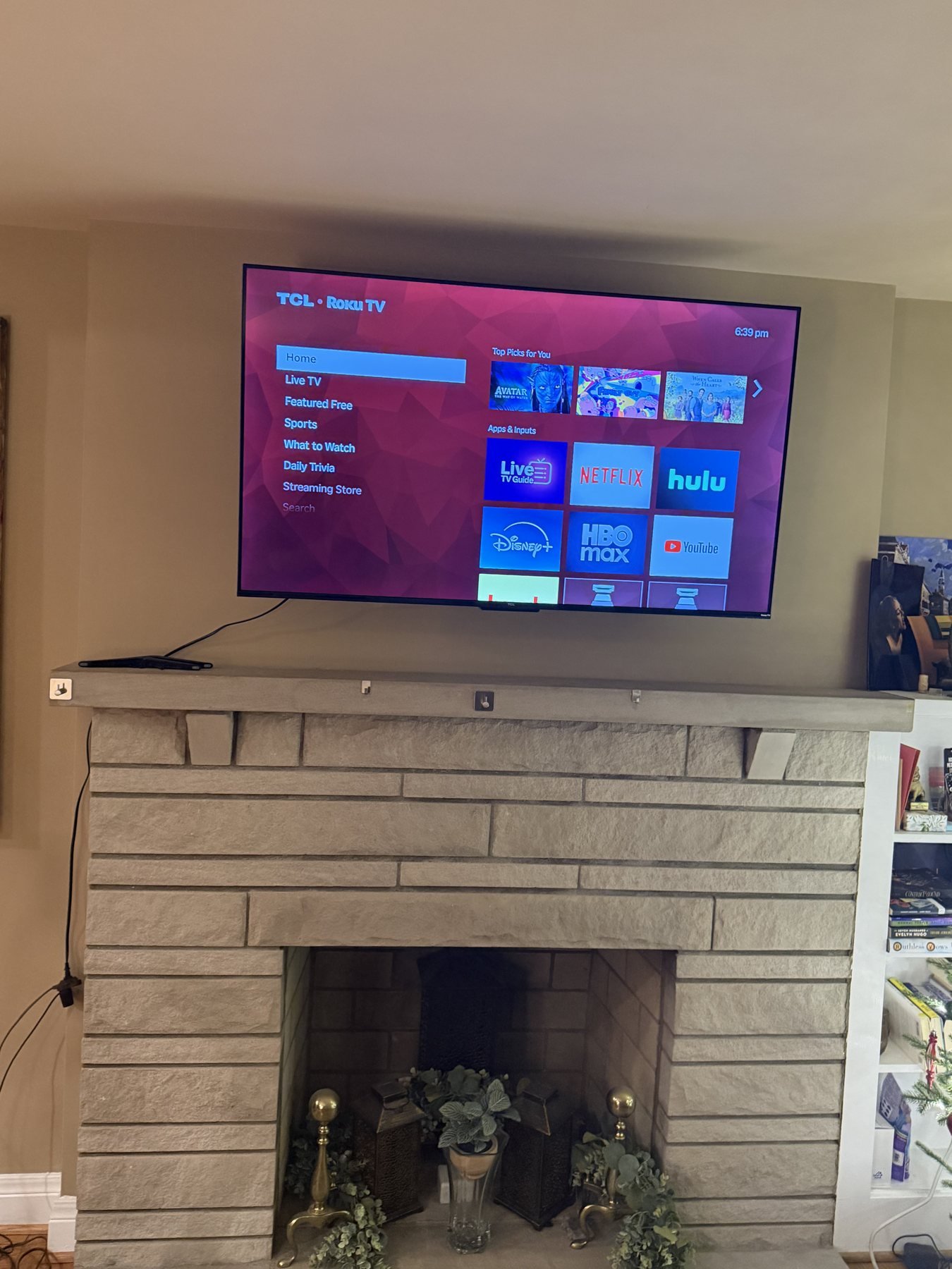 TV Mounting in St. Matthews, KY 55-inch TV mounted above a tan brick fireplace and mantel in St. Matthews, Kentucky
