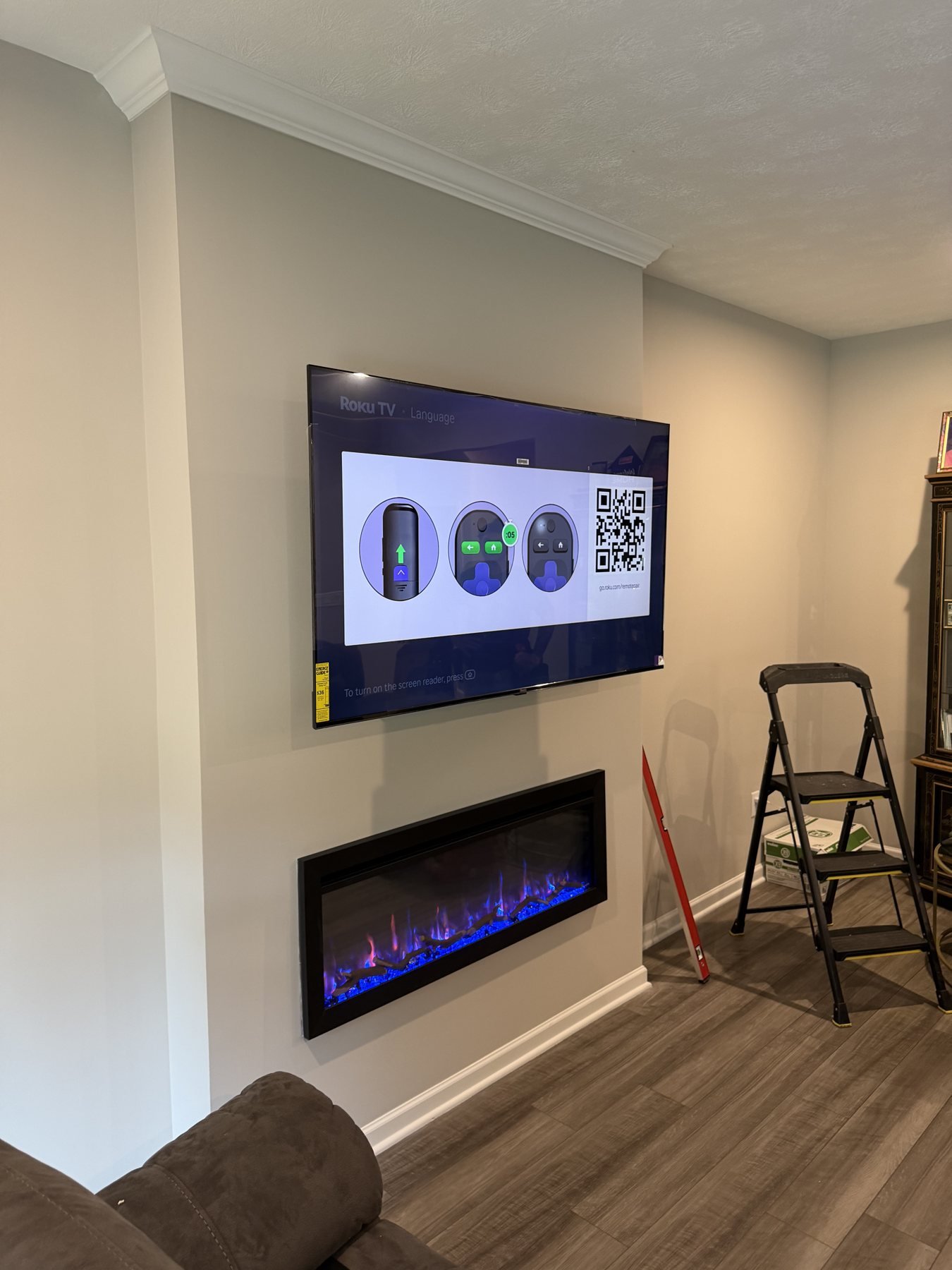 TV Mounting Above Electric Fireplaces TV above a long recessed electric fireplace in a painted feature wall